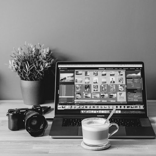 A cup of coffee in front of a laptop completing a digital purchase order