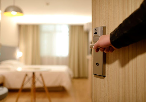 Guest holding door of a hotel room